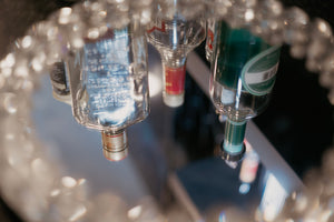 Liquor bottles reflected in a luxury mirror at VONCII.